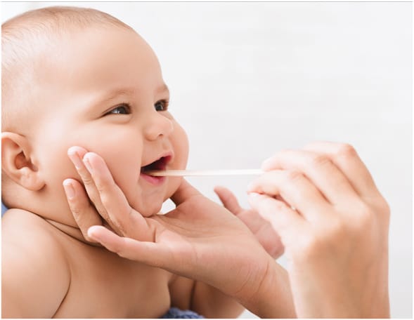 A dentist examines the dental health of an infant